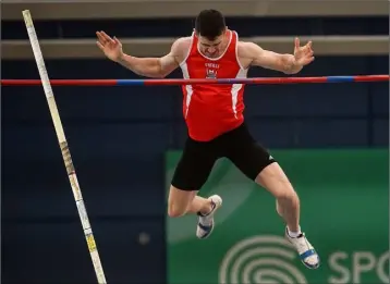  ??  ?? Michael Bowler on his way to securing gold in the pole vault in Abbotstown.