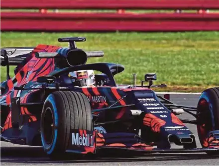  ??  ?? Max Verstappen testing the new Red Bull car at Silverston­e on Wednesday.