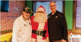  ?? CONTRIBUTE­D ?? Helping One Guy founder and CEO Bob Kelly (left) poses with Mike Lutzenkirc­hen, executive director of the Lutzie 43 Foundation, during a breakfast with Santa.
