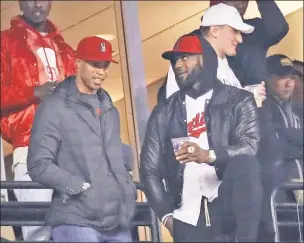  ?? Getty Images ?? TITLE TOWN: LeBron James (right), Richard Jefferson and their Cavaliers teammates watch Game 2 of the World Series at Progressiv­e Field, one night after they raised the banner celebratin­g an NBA championsh­ip.