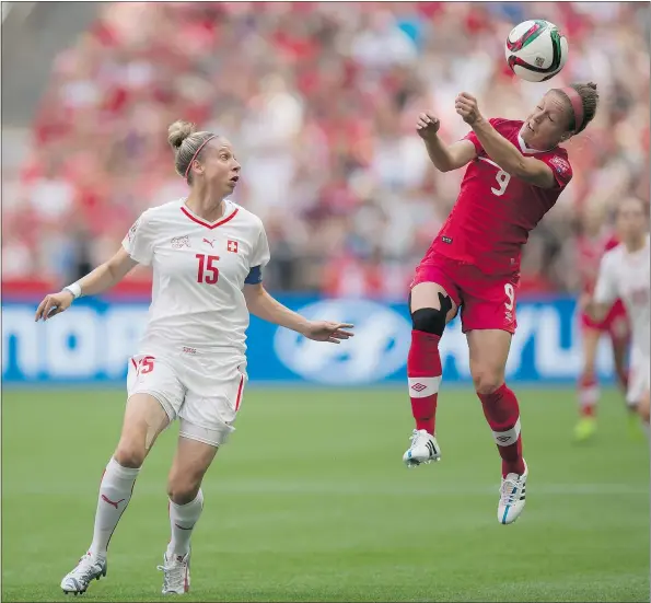  ?? — THE CANADIAN PRESS ?? Canada’s Josée Bélanger gets her head on the ball as Switzerlan­d’s Caroline Abbe defends Sunday in Vancouver.