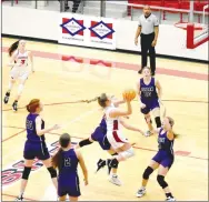  ?? MARK HUMPHREY ENTERPRISE-LEADER ?? Farmington senior Carson Dillard seems to dance on air as she drives to the basket during the Lady Cardinals’ firstround game against Ozark once the 4A North Regional got going Saturday at Cardinal Arena.