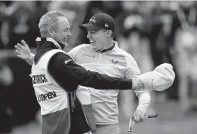  ?? Robert F. Bukaty/Associated Press ?? Matt Fitzpatric­k, with veteran caddie Billy Foster, is a popular champion at a tumultuous time when golf needed a feel-good story.