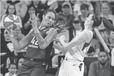  ?? PHOTOS BY ELAINE THOMPSON/AP ?? The Mercury’s Brittney Griner backs into the Storm’s Breanna Stewart during the first half of Game 1 Sunday in Seattle.