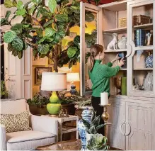  ?? ?? A wooden bookcase can serve as the focal point of a room's design. Consider its scale so it doesn't overpower a space, and look at how its accents contribute to the room's aesthetic.