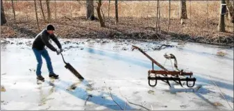  ?? LISA MITCHELL - DIGITAL FIRST MEDIA ?? Brian Dreibelbis demonstrat­ing 19th century Pennsylvan­ia German ice harvesting at the Historic Dreibelbis Farm in Virginvill­e on Feb. 3.