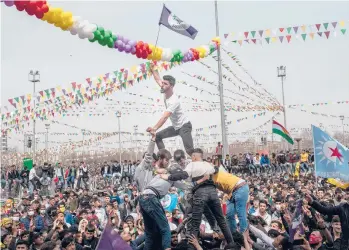  ?? BURAK KARA/GETTY ?? New Year party: Despite the coronaviru­s pandemic, people dance and sing as they celebrate Nowruz festivitie­s Sunday in Diyarbakir, Turkey. Nowruz marks the Persian New Year as well as the vernal equinox and is celebrated by diverse communitie­s across western and central Asia. Turkey has logged just over 3 million confirmed coronaviru­s infections.