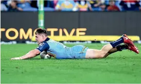  ?? GETTY IMAGES ?? AJ Brimson scores a try for the Gold Coast Titans.