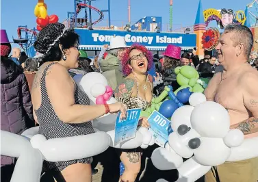  ?? Picture: REUTERS ?? ICY NEW YEAR PLUNGE: People dance on the boardwalk after participat­ing in the annual Polar Bear Plunge in Coney Island in the Brooklyn Borough of New York City on New Year’s Day. Thousands of people across North America in Coney Island, Florida, and...