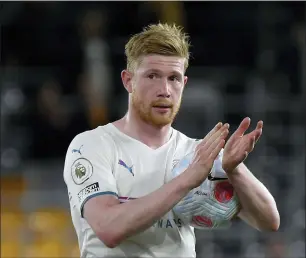  ?? RUI VIEIRA — THE ASSOCIATED PRESS ?? Manchester City’s Kevin De Bruyne leaves the field with the match ball at the end of Wednesday’s English Premier League match between Wolverhamp­ton Wanderers and Manchester City.