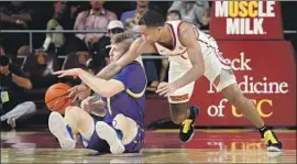  ?? Gina Ferazzi Los Angeles Times ?? USC GUARD Kyle Sturdivant tries for a steal against South Dakota State’s Baylor Scheierman in the Trojans’ 84-66 victory Tuesday night at Galen Center.