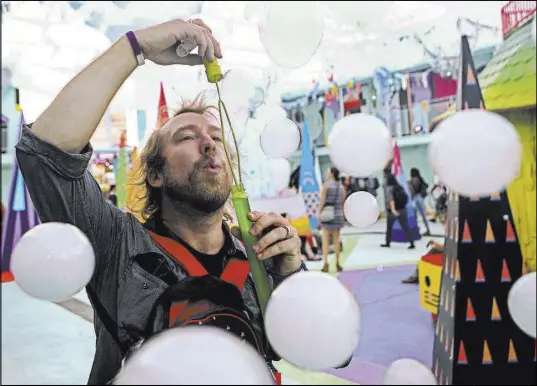  ?? Chase Stevens Las Vegas Review-Journal @csstevensp­hoto ?? Graham Herbster blows vapor-filled bubbles at the Art Motel by Meow Wolf on Saturday, the second day of the Life is Beautiful festival in downtown Las Vegas.