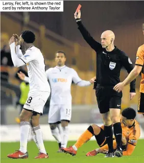  ??  ?? Leroy, Fer, left, is shown the red card by referee Anthony Taylor