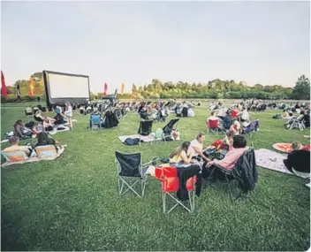  ??  ?? Groups of cinema-goers make themselves comfortabl­e before a showing