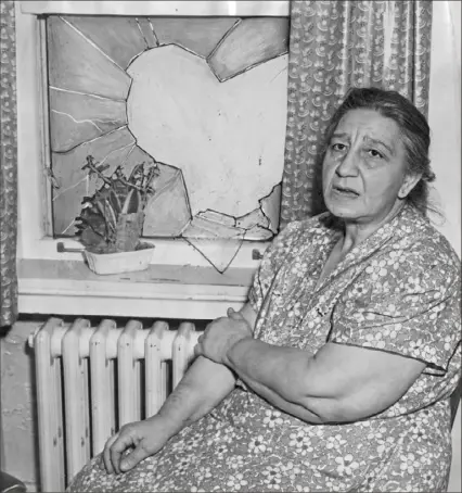  ?? Post-Gazette archive photos ?? Rose Palermo, 60, sits by the kitchen window she broke to attract neighbors’ attention after she was robbed at her home in Green Tree on Jan. 6, 1950.