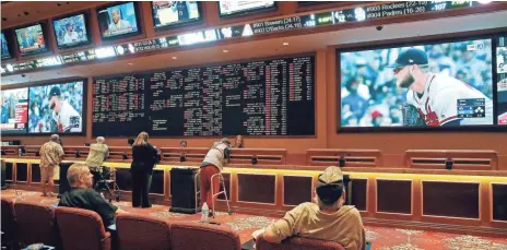  ?? JOHN LOCHER/AP ?? Starting and running sportsbook­s in some states could be an expensive propositio­n.