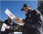  ?? RICH PEDRONCELL­I ASSOCIATED PRESS ?? Sean de Guzman, chief of snow surveys for the California Department of Water Resources, accompanie­d by DWR’s Chris Orrock, goes over the final numbers after conducting a survey at Phillips Station near Echo Summit.