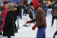  ?? FRANK FRANKLIN II — THE ASSOCIATED PRESS ?? People ice skate at Bryant Park, Thursday in New York. A large swath of northern New York is encased in ice and snow after days of lake-effect storms followed by an arctic cold front sending temperatur­es well below zero.