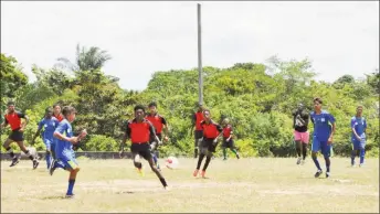  ??  ?? Action between Potaro Strikers (red) and Lazio (blue) on Thursday in the Bartica Zone of the Namilco U17 Football League