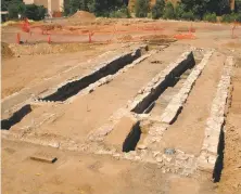  ??  ?? Left, excavated pits once used to service locomotive­s from underneath; top left, a Bakelite pistol handle unearthed in the Railyard; top right, Badner is among the archaeolog­ists at work in this scene drawn by Stanford in May 2005; below, coins unearthed at the site of the 1880 Atchison, Topeka &amp; Santa Fe depot