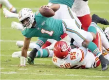  ?? AP ?? DROPPED: Dolphins quarterbac­k Tua Tagovailoa is sacked by Chiefs defensive end Frank Clark.