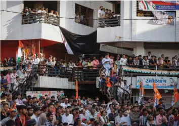  ?? (Amit Dave/Reuters) ?? SUPPORTERS OF Rahul Gandhi, a senior leader of India’s main opposition Congress party, listen to his speech in Jhalod town, Gujarat state, last month.