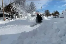 ?? Photograph: Bridget Haslinger/AP ?? Martin Haslinger uses a snowblower outside his home in Buffalo, New York, on Saturday following a lake-effect snowstorm.