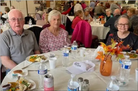  ?? COURTESY OF JOANNA REAGAN ?? From left, is Ken Lohrman, Beverly Mcpherson, and Carol Kilbourn enjoyed the annual Thanksgivi­ng Day dinner at the Albert Harris Center in Pepperell.