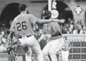  ?? Karen Warren / Staff photograph­er ?? Chas McCormick celebrates with Jose Siri after being hit by a pitch to bring in the winning run Friday.