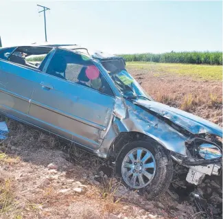  ??  ?? The written-off car at the quarry entry at the base of Devil’s Chair, on Cook’s Lane between Ingham and Halifax, Hinchinbro­ok Shire. Picture: Cameron Bates