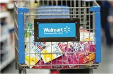  ?? — Reuters ?? A customer pushes a shopping cart at a Walmart store in Chicago.