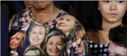  ?? REUTERS ?? A woman wears a T- shirt with pictures of Hillary Clinton during a campaign rally at Ernst Community Cultural Center in Annandale, Virginia, on Thursday.