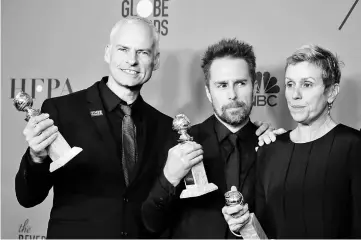  ??  ?? McDonagh, Rockwell and McDormand pose backstage with their Golden Globe awards for ‘Three Billboards Outside Ebbing, Missouri’. — Reuters file photo