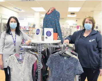  ??  ?? Getting ready Assistant mnager Karen Nottingham and manager Steph Florence prepare to reopen Crieff’s Cancer Research charity shop