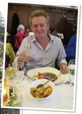  ??  ?? CHEERS: Giles raises a glass before tucking into his pork at the Hotel Victor Hugo in the beautiful village of Vianden, left