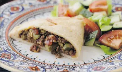  ?? — CANADIAN PRESS ?? Use local produce to whip up this family-sized beef and vegetable empanada.