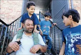  ?? Gary Coronado Los Angeles Times ?? A FAMILY that came from Syria relaxes outside their home in Fort Worth.