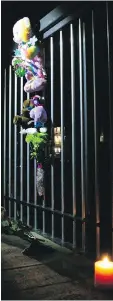  ??  ?? Residents of an Airdrie, Alta., neighbourh­ood set up a makeshift memorial on a bridge above the drainage canal in which a six-yearold drowned on Monday.