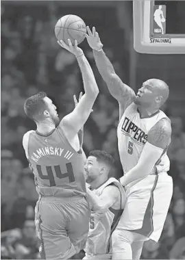  ?? Mark J. Terrill Associated Press ?? BACKUP CENTER Marreese Speights (5) goes high and guard Austin Rivers goes low as the two Clippers contest a shot by Charlotte’s Frank Kaminsky III.