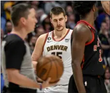  ?? AARON ONTIVEROZ — THE DENVER POST ?? The Nuggets’ Nikola Jokic, center, looks on during Monday’s game against the Raptors at Ball Arena in Denver.