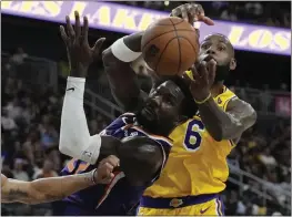  ?? JOHN LOCHER — THE ASSOCIATED PRESS ?? The Lakers' LeBron James (6) battles Suns center Deandre Ayton for a loose ball during Wednesday night's preseason game in Las Vegas. James scored 23points in L.A.'s loss.