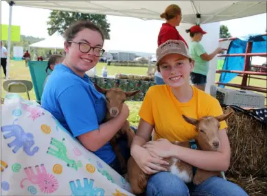  ?? LAUREN HALLIGAN - MEDIANEWS GROUP ?? Sisters Maeve and Nessa Corcoran hold twin baby goats Nigerian dwarf goats at Rensselaer County’s second annual Farm Day Out.