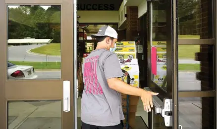  ?? STAFF PHOTO BY C.B. SCHMELTER ?? Pacey Smith helps deliver snacks for the vending machines at Chattooga County High School on Tuesday in Summervill­e, Ga. Thursday is the first day of school for more than 2,600 students in the Chattooga County Schools system.