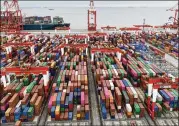  ?? KEITH BRADSHER/NYT ?? Containers sit June 17 at the port in Shanghai, China. A virus outbreak closed a port near Shenzhen, flooding other Chinese ports like Shanghai.