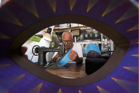  ?? — Bernama ?? For a neater finish: Haja Mohideen stitching songkok with the sewing machine his father bequeathed him at his shop in George Town.