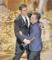  ?? Kevin Winter Getty Images ?? “SPOTLIGHT” screenwrit­er Josh Singer, left, and actor Mark Ruffalo celebrate the best picture Oscar.