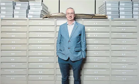  ?? MATHEW MCCARTHY, RECORD STAFF ?? Nick Richbell, an archivist at the University of Waterloo, stands near cabinets that contain around three million negatives from the Waterloo Region Record.