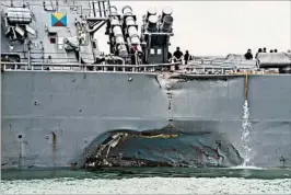  ?? JOSHUA FULTON/U.S. NAVY ?? The hobbled USS John S. McCain rests Monday at Changi Naval Base in Singapore.
