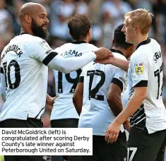  ?? ?? David Mcgoldrick (left) is congratula­ted after scoring Derby County’s late winner against Peterborou­gh United on Saturday.