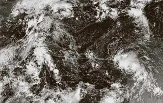  ?? National Oceanic and Atmospheri­c Associatio­n via New York Times ?? Tropical Storm Laura, right, forms Friday, the latest named storm of a busy Atlantic hurricane season, while another system, then known as Tropical Depression 14, left, churns its way toward the Gulf of Mexico. TD14 was upgraded to Tropical Storm Marco late Friday.